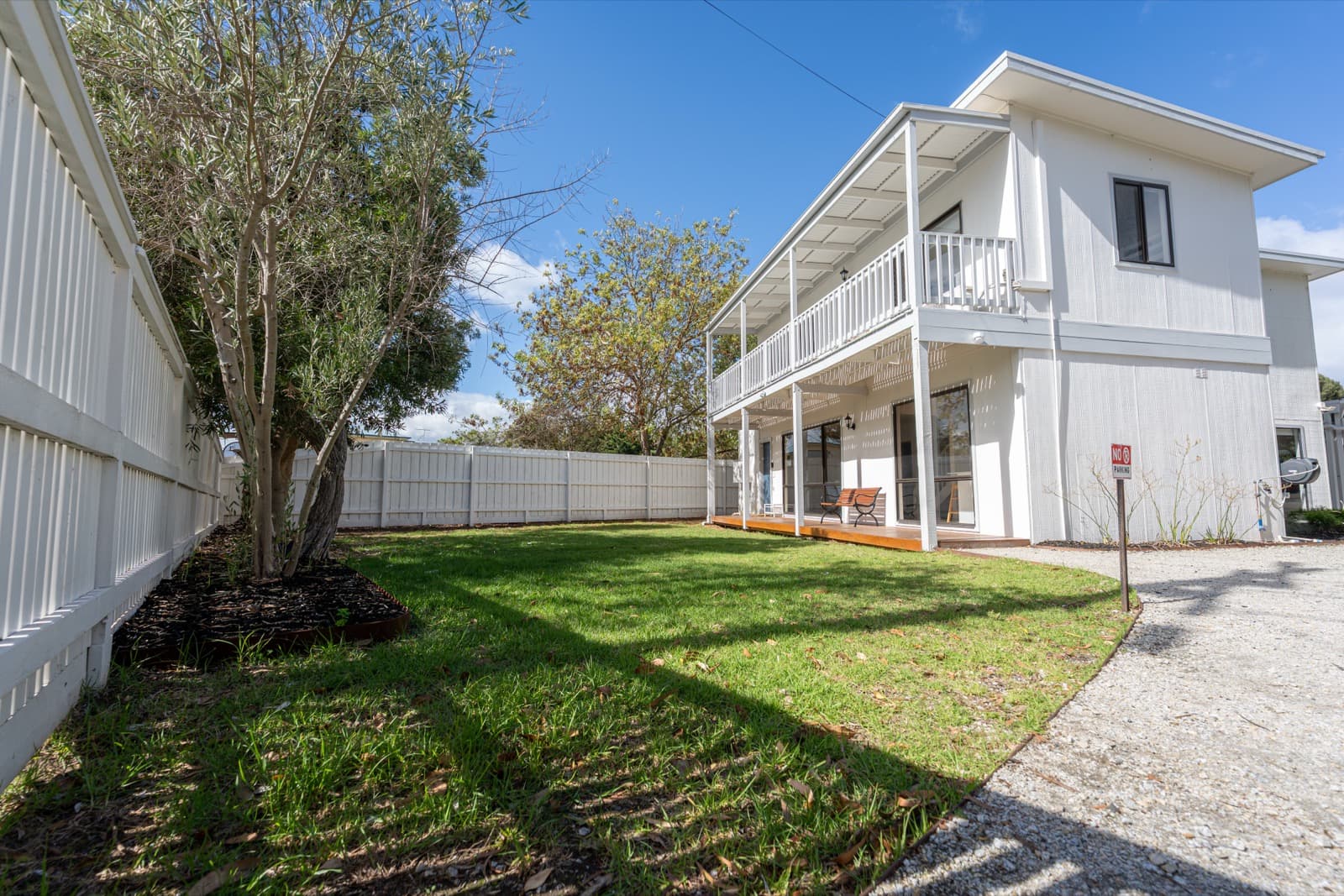 Front yard with lawn and double-storey exterior at Big Isle Retreat, Cowes
